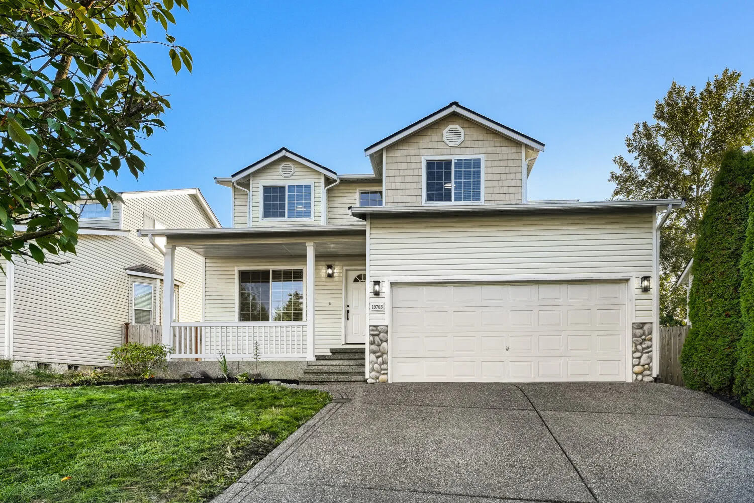 Two story Craftsman home with covered porch and attached two car garage