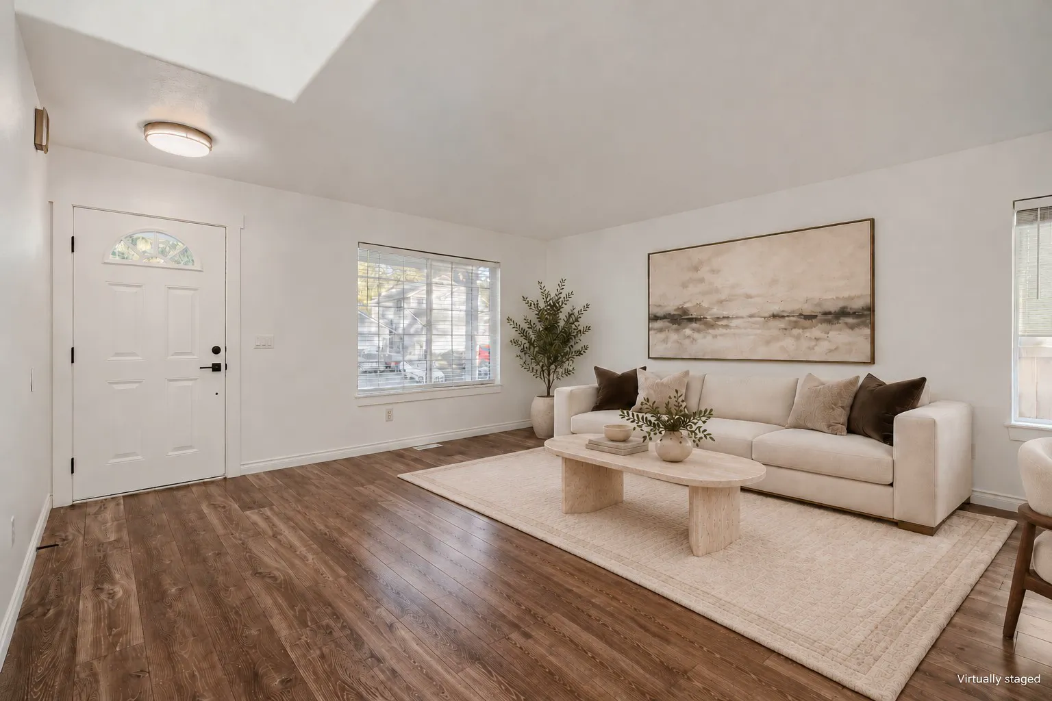 Formal living room with front window, virtually staged